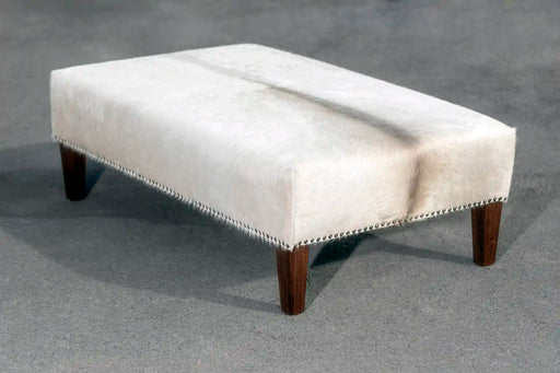 Light cowhide ottoman with studs